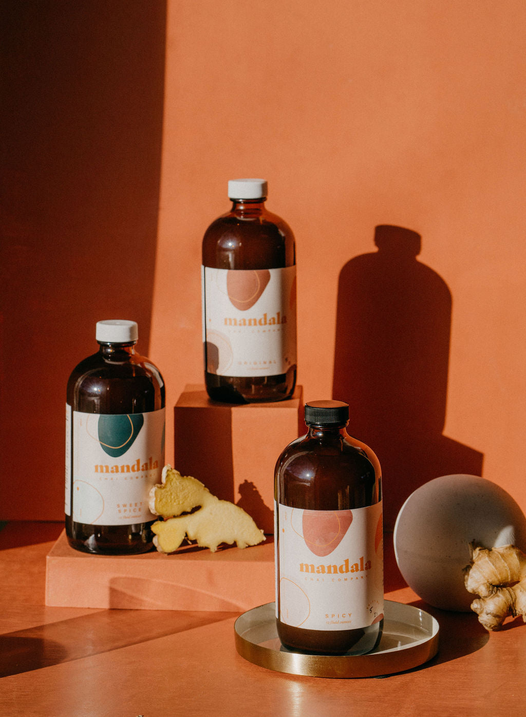Mandala chai bottles with fresh-cut ginger