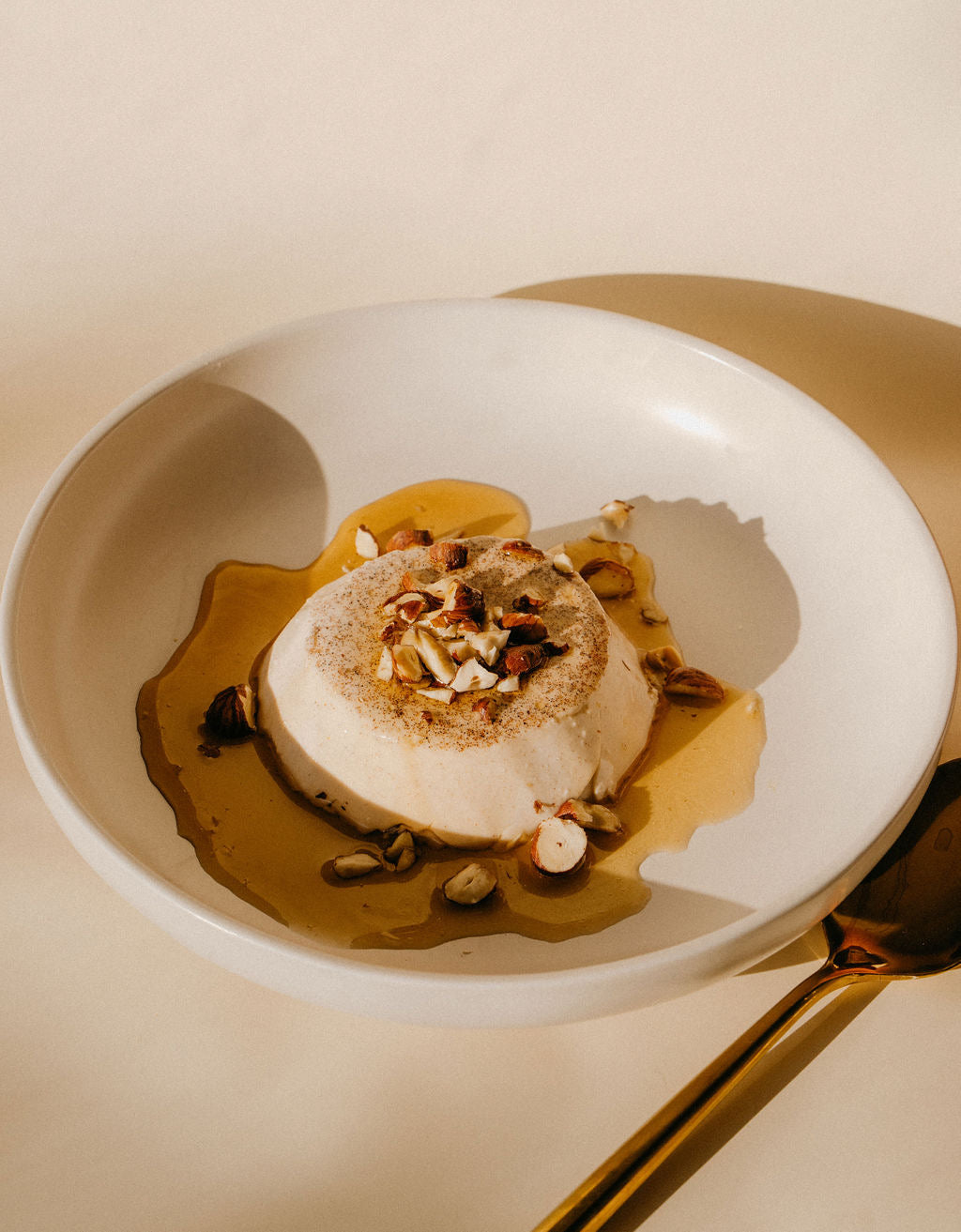 Chai spiced panna cotta with maple caramel and hazelnuts