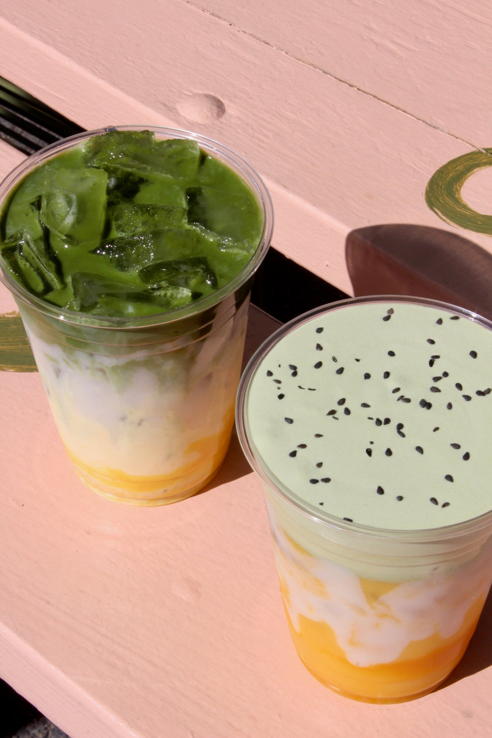 Overhead view of two layered matcha drinks