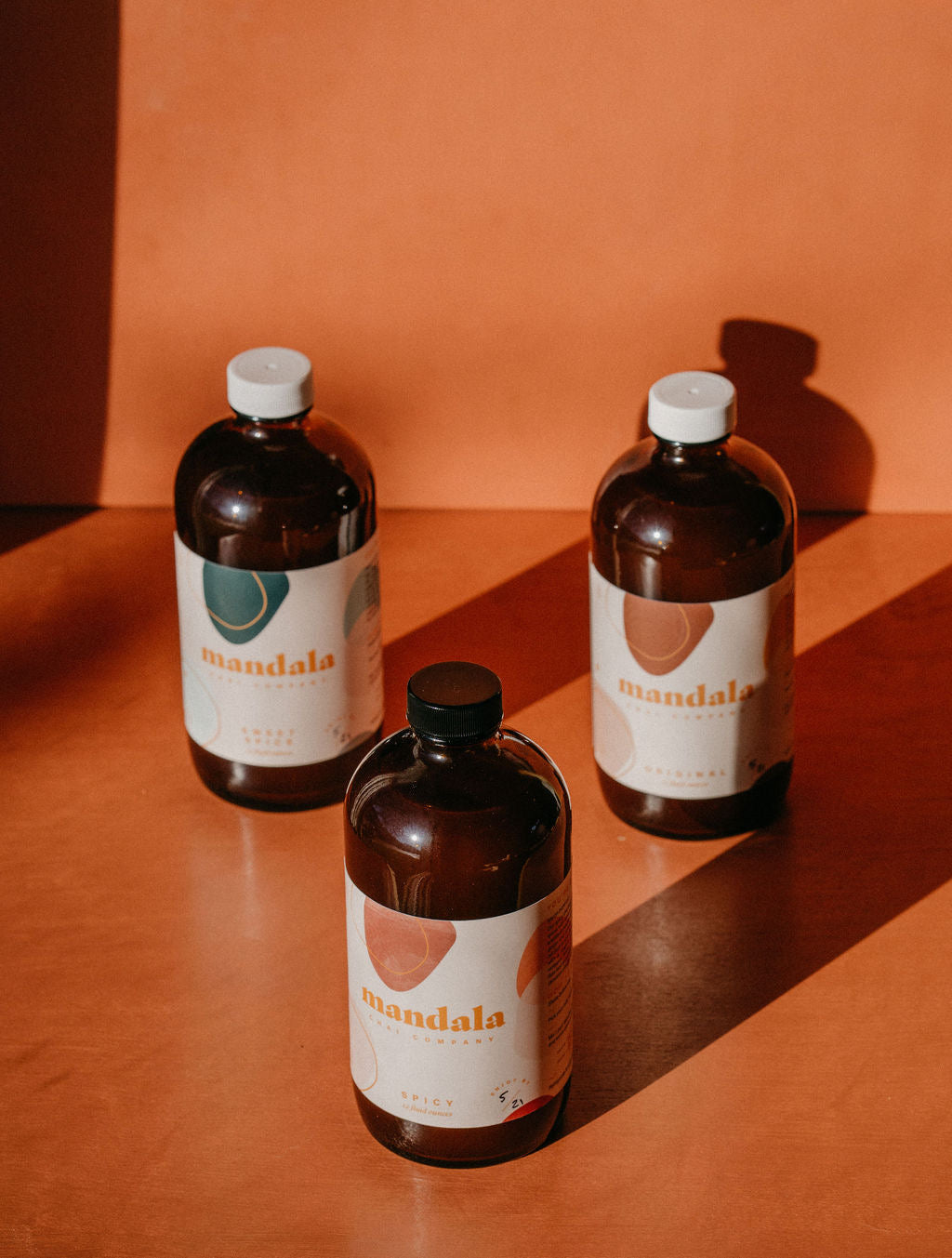 Spicy chai bottle in front of Original and Sweet Spice in late-day light