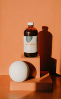 Mandala Sweet Spice chai concentrate in an amber bottle on a terracotta block